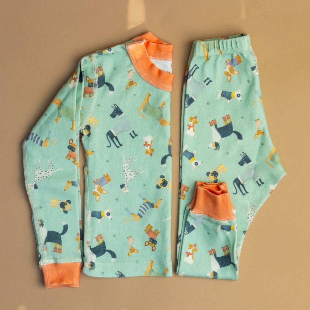 Teal organic pajama set with orange crew collar and playful animal print, long sleeves