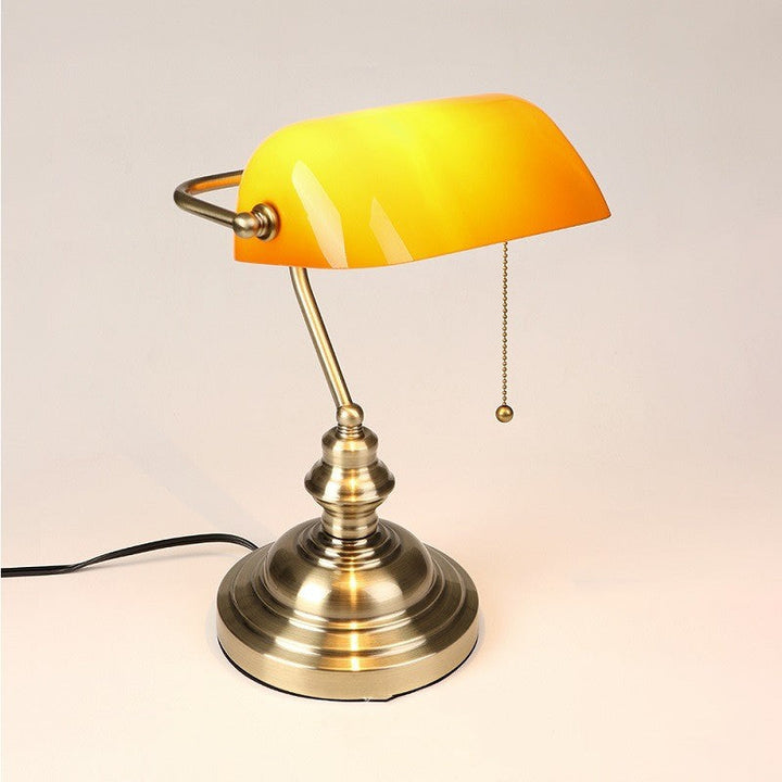 Orange mini desk lamp with dome shade, antique brass base and pull cord
