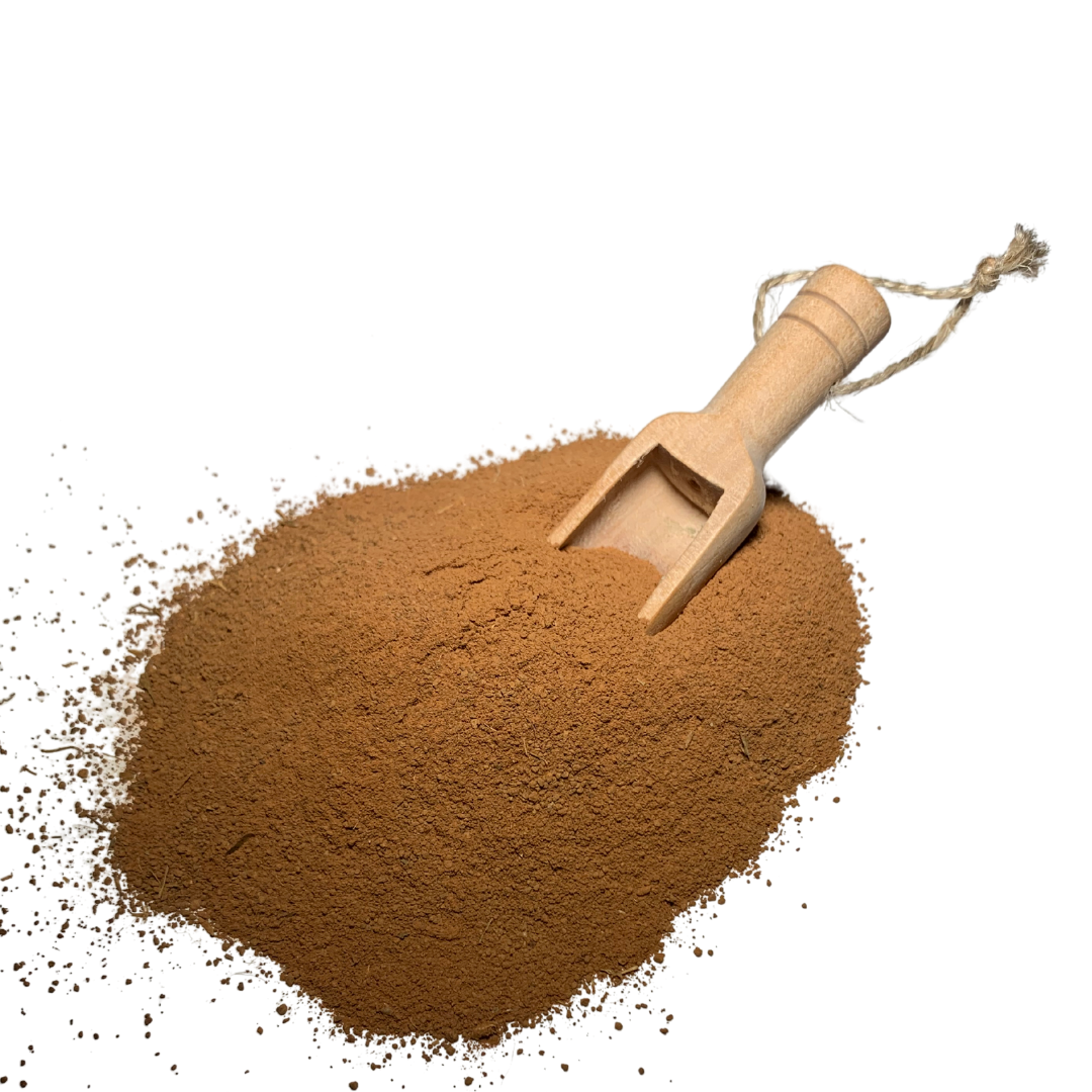 Mud and arnica mask powder in wooden scoop, loose brown clay