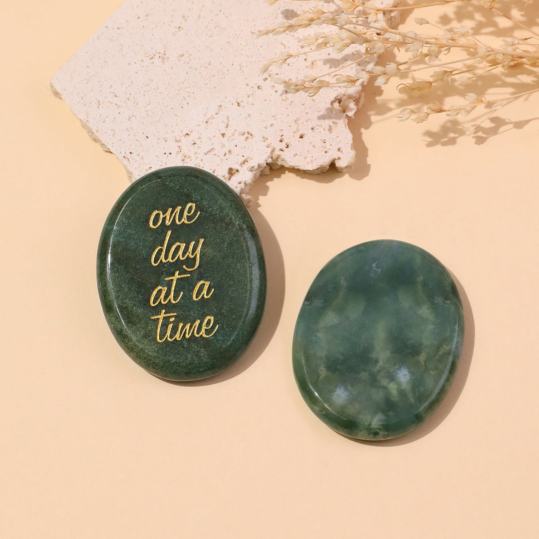 Green round pocket crystal stone with gold “one day at a time” text