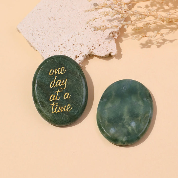 Green round pocket crystal stone with gold “one day at a time” text