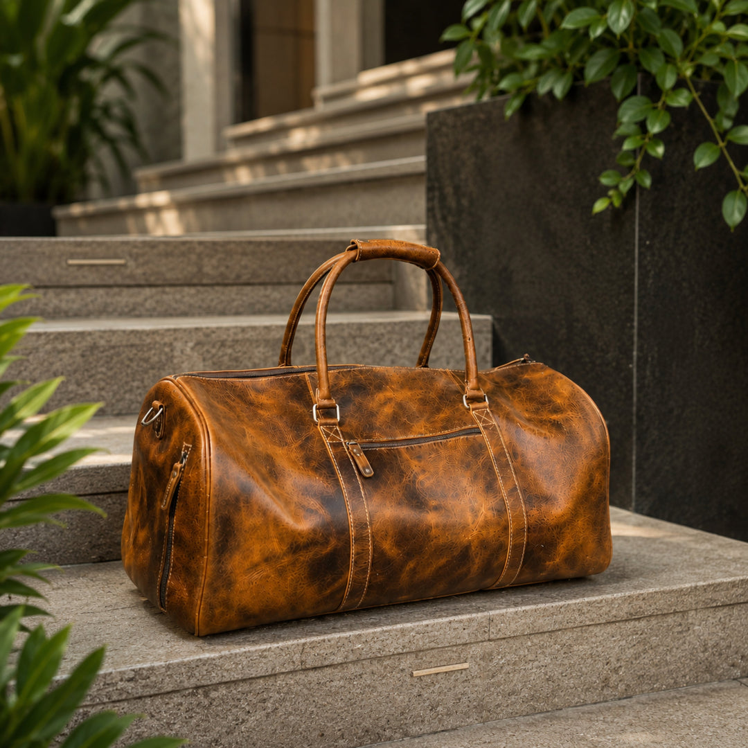 Brown leather duffel bag with rounded handles and front zipper pocket on steps.