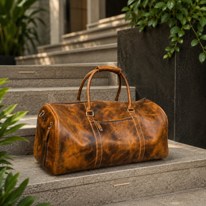 Brown leather duffel bag with rounded handles and front zipper pocket on steps.