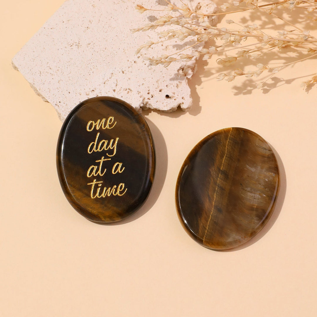 Brown round pocket crystal stone with gold “one day at a time” text