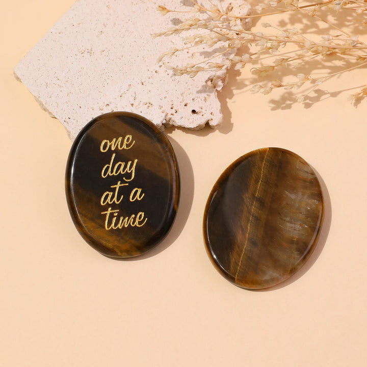 Brown round pocket crystal stone with gold “one day at a time” text