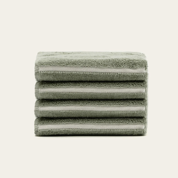 Sage green cotton towels folded stack with horizontal stripe detailing