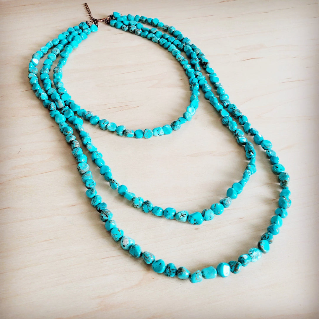 Turquoise triple-strand beaded necklace with brown chain closure