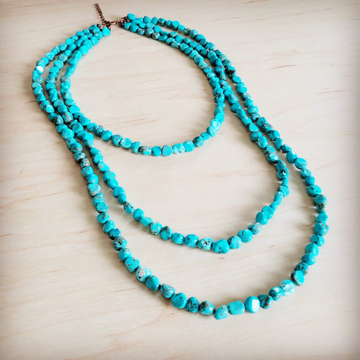 Turquoise triple-strand beaded necklace with brown chain closure
