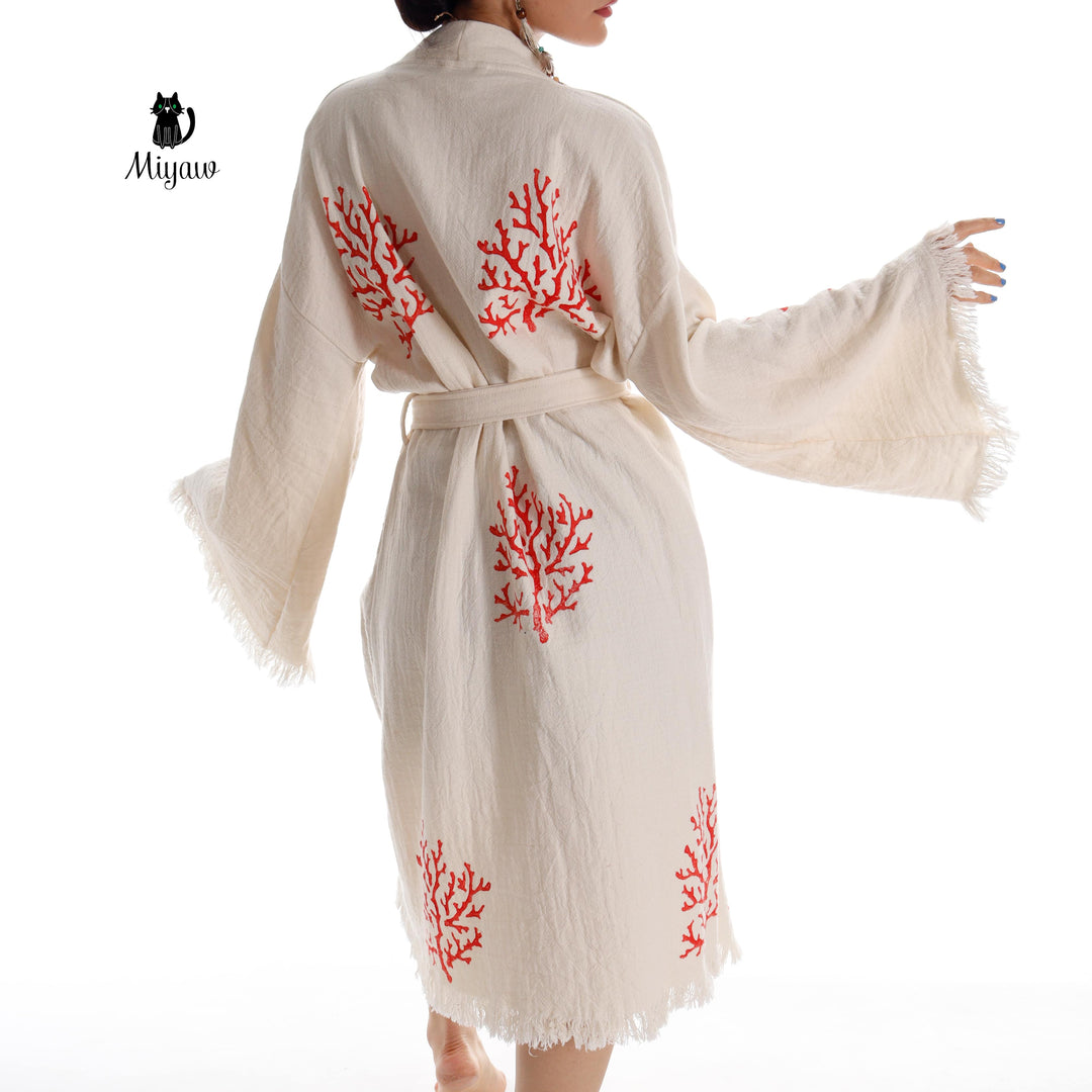 Beige kimono robe back view with red coral tree embroidery and tied waist, fringe trim
