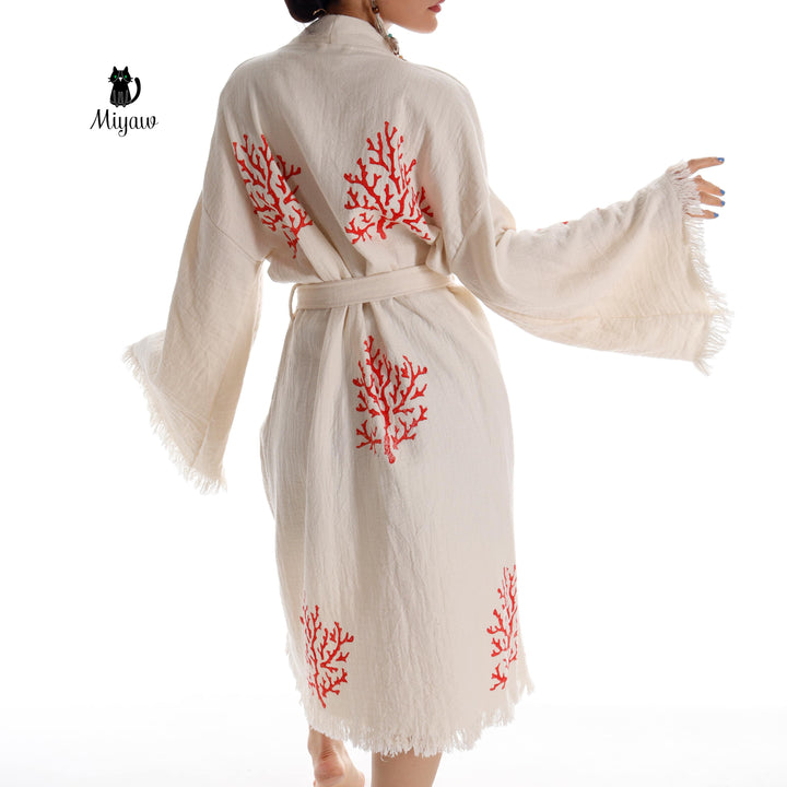 Beige kimono robe back view with red coral tree embroidery and tied waist, fringe trim