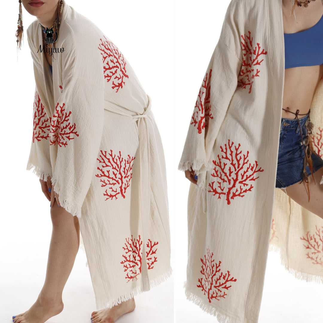 Beige organic cotton kimono with red coral tree motifs, open front and fringed edges