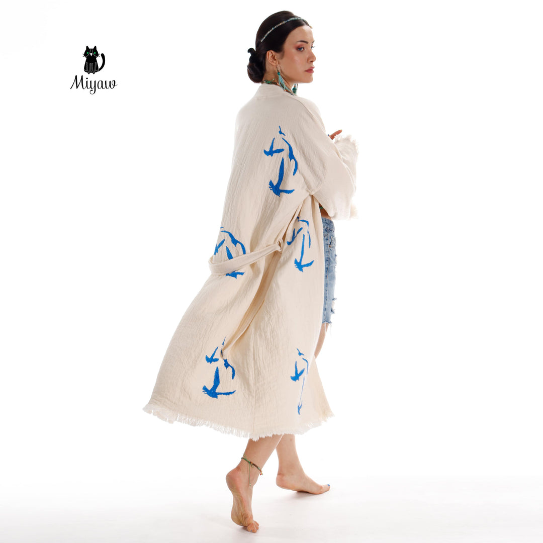 Beige seagull-print kimono robe with flowing sleeves, tied waist belt, fringe edges