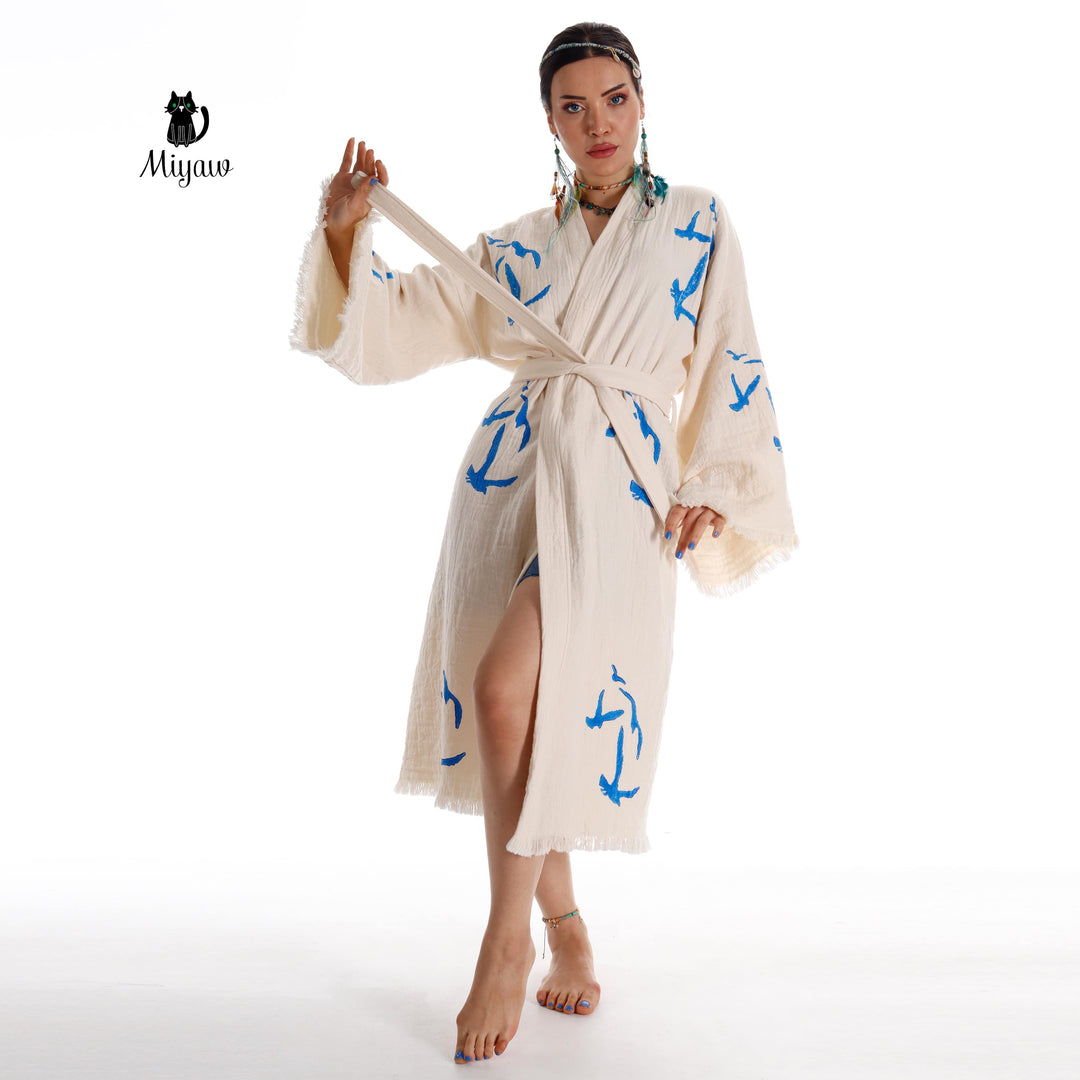 Beige seagull-print kimono robe with tied waist, open wrap front, fringe cuffs