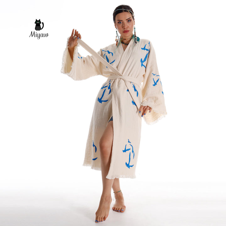 Beige seagull-print kimono robe with tied waist, open wrap front, fringe cuffs