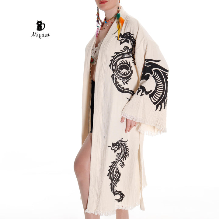 Beige cotton kimono robe with black dragon pattern, open front and fringed sleeve ends