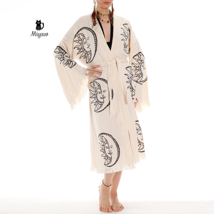 Beige organic cotton kimono robe with moon-and-sun face print, draped open front, belt tie