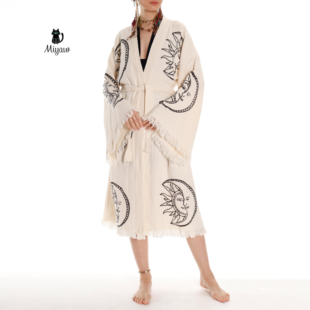 Beige organic cotton kimono robe with moon-and-sun face print, long sleeves with fringe