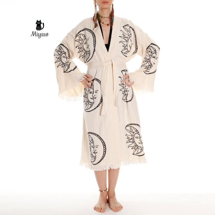 Beige organic cotton kimono robe, front view, moon-and-sun face print, fringed sleeve hems
