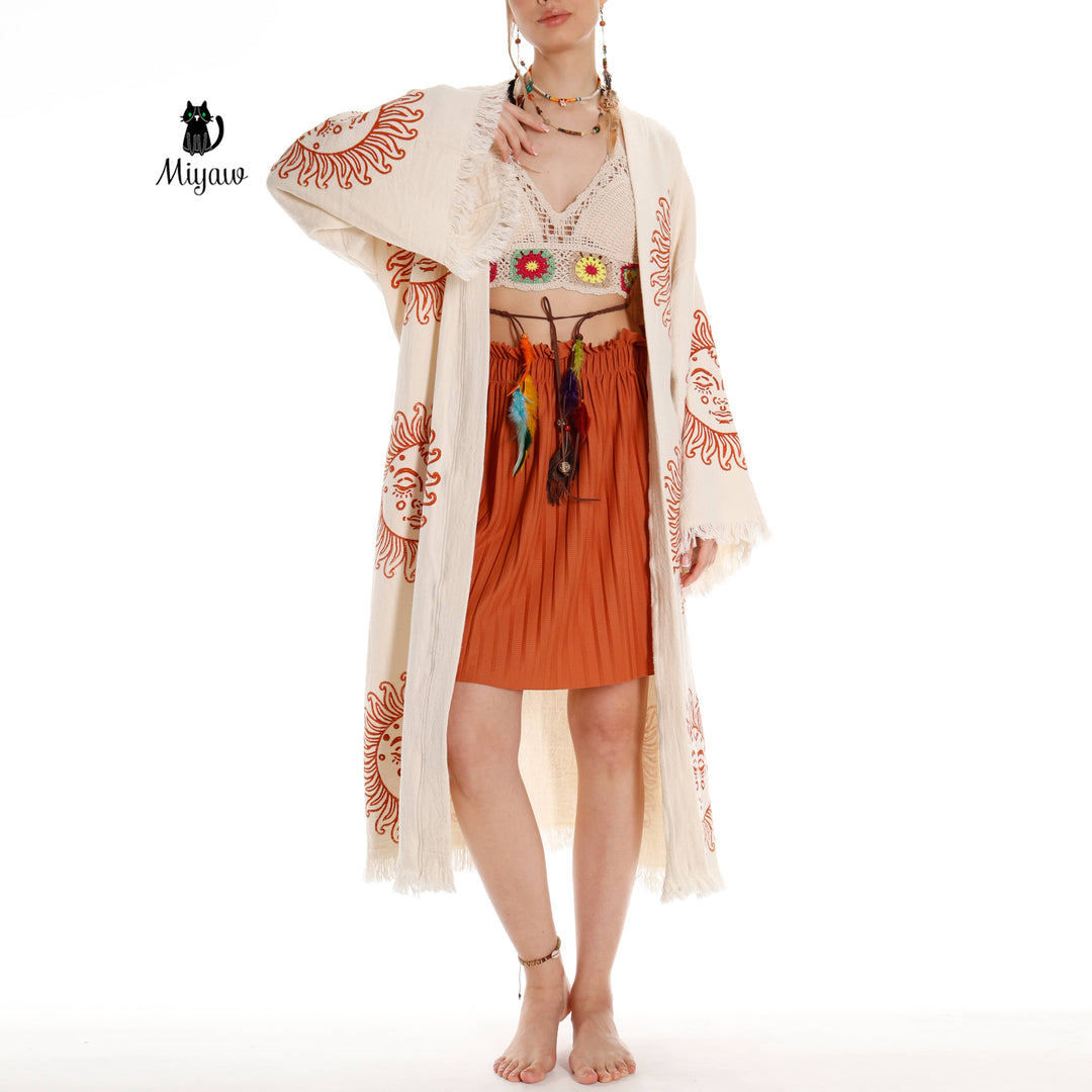 Beige cotton kimono robe with orange sun-face motifs and fringed edges, side view