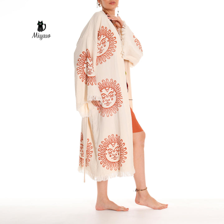 Beige cotton kimono robe with large orange sun-face prints and fringed sleeves