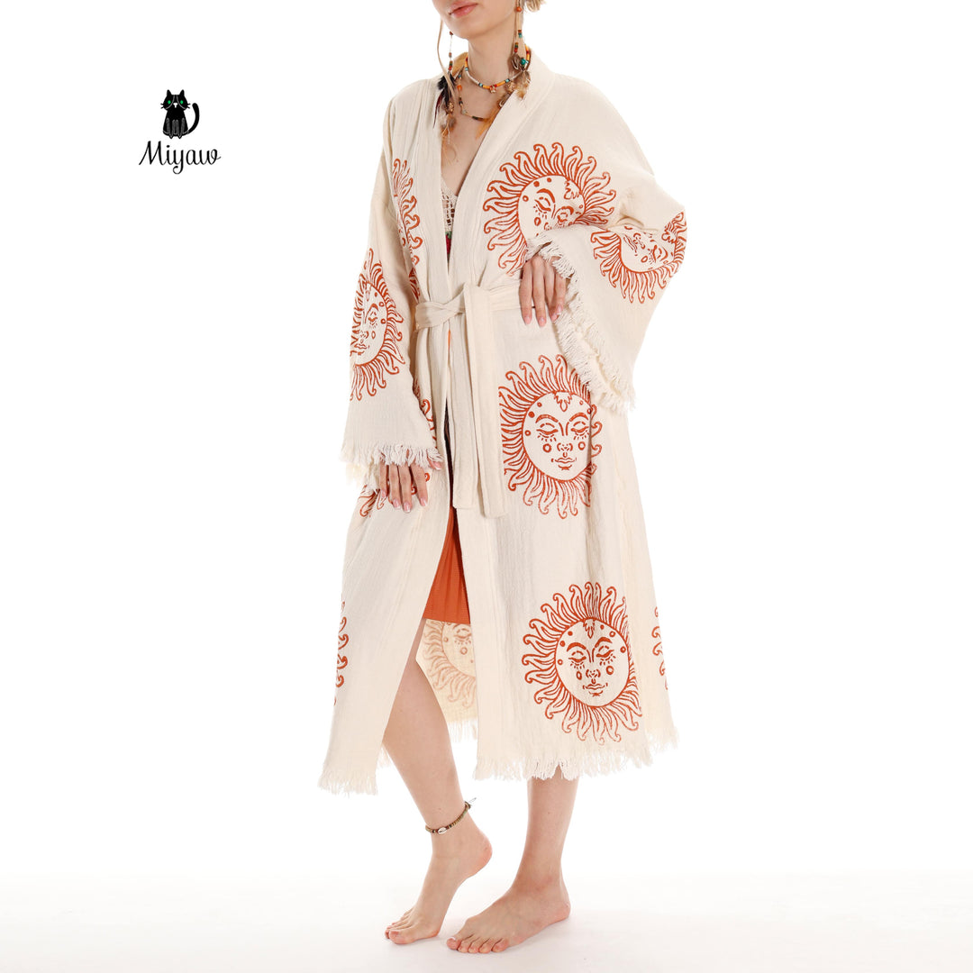 Beige cotton kimono robe with orange sun-face print and tied waist, full length