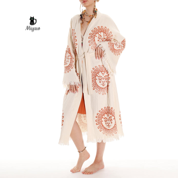 Beige cotton kimono robe with orange sun-face print and tied waist, full length