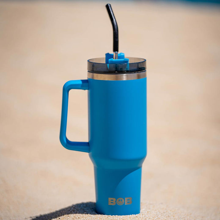 Blue 40oz tumbler with straw and handle, ready to drink
