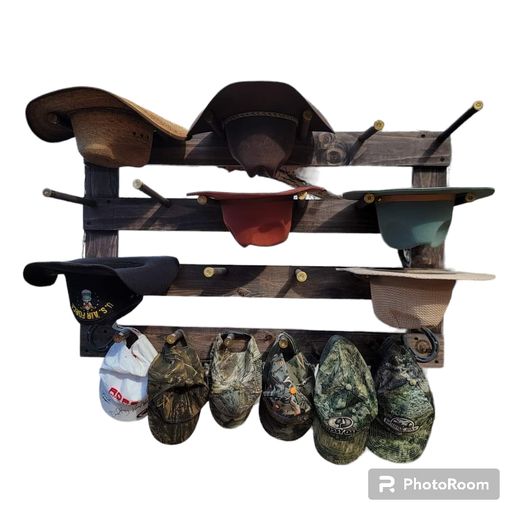 Wall-hanging hat organizer on white background with several hats on horizontal rails