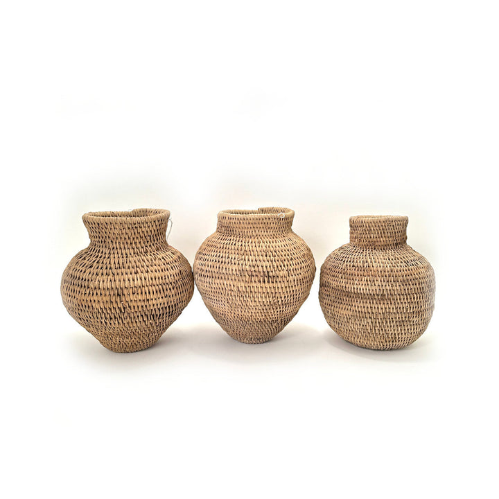 Set of three woven jute baskets with rounded tops in varying heights