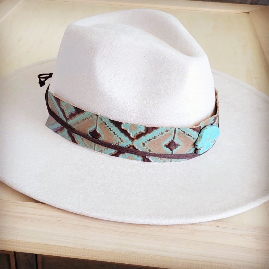 White felt cowboy hat with turquoise leather band and turquoise concho near brim