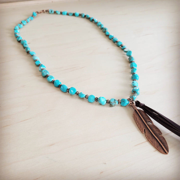 Turquoise bead necklace with bronze feather pendant and black leather tassel