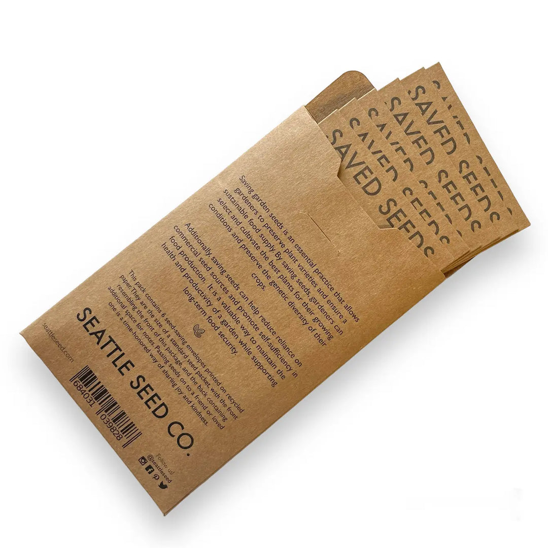 Set of kraft seed envelopes stacked, printed with saved seeds and Seattle Seed Co