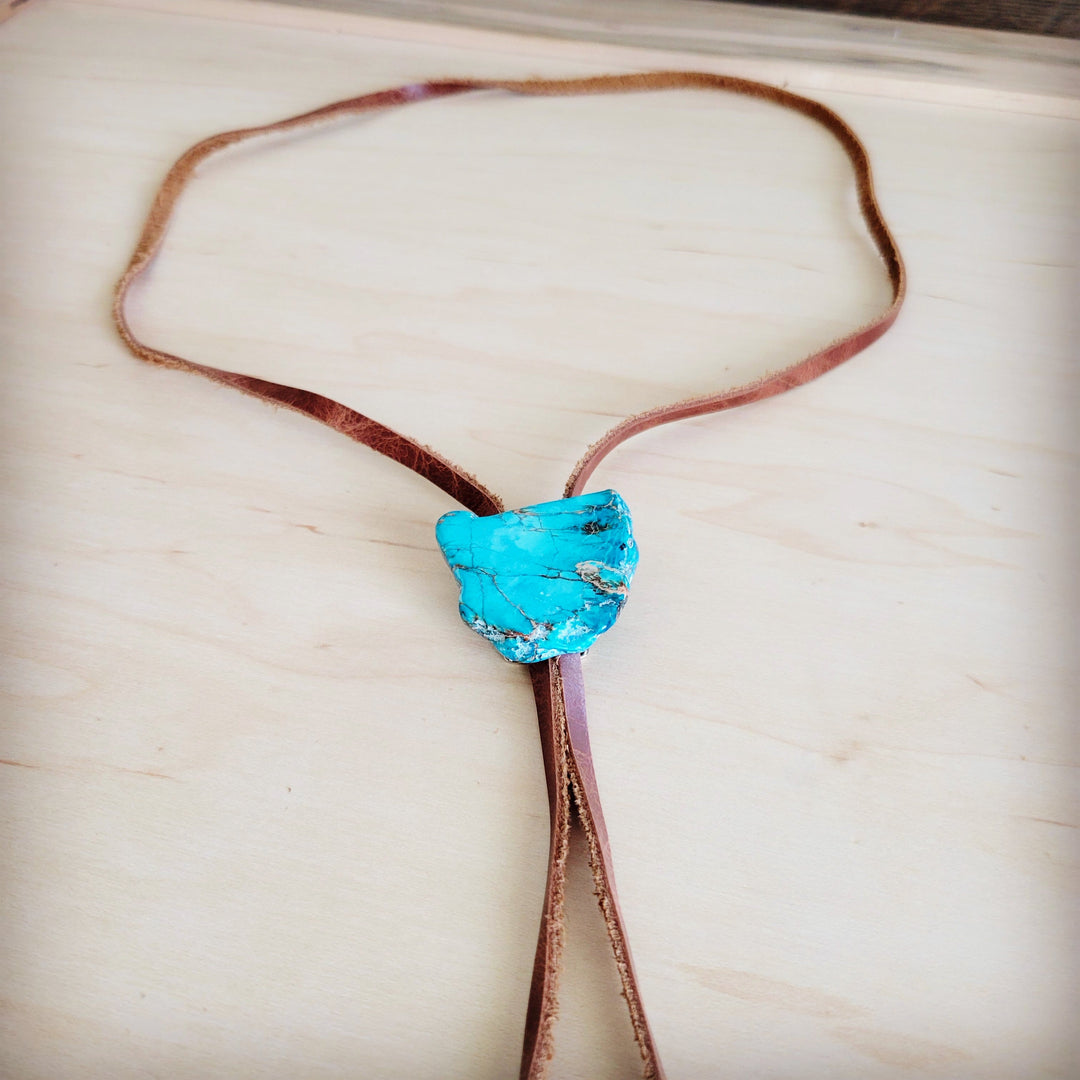 Brown leather lariat necklace featuring a large blue stone slab pendant at center