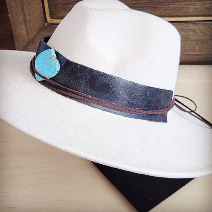 White felt wide-brim hat with dark leather hat band and turquoise heart ornament