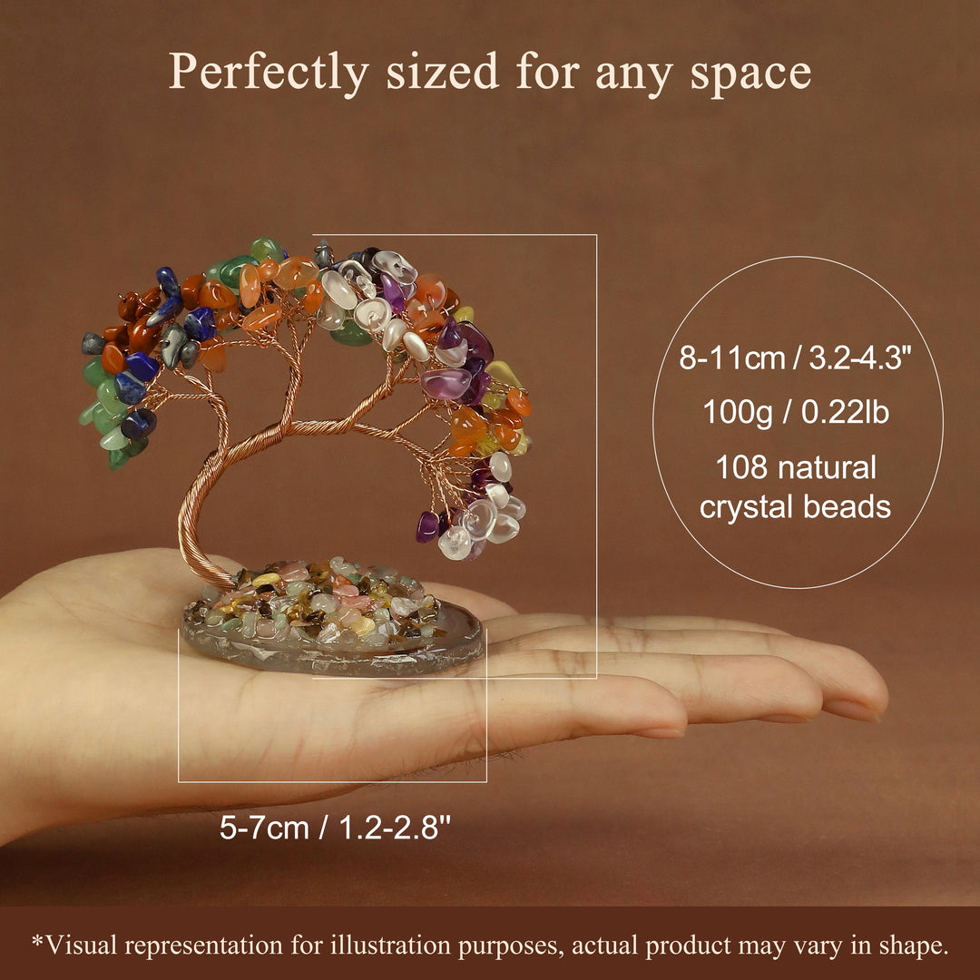 Multicolor beaded crystal tree ornament on round stone base, held in hand