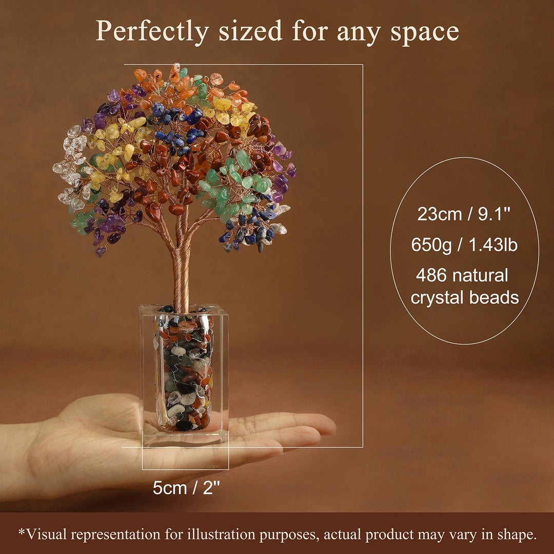 Crystal tree ornament with rainbow beads in a clear cube stand, held in hand