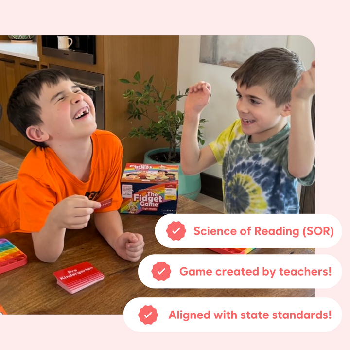 Children playing a sight words board game at a wooden table with cards