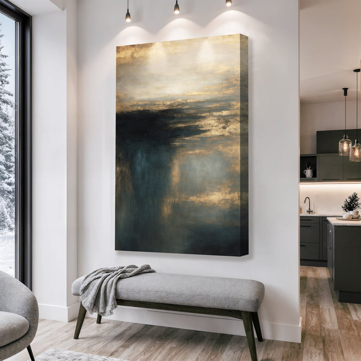 Vertical framed cloudscape wall art with gold clouds and teal shadows above bench.