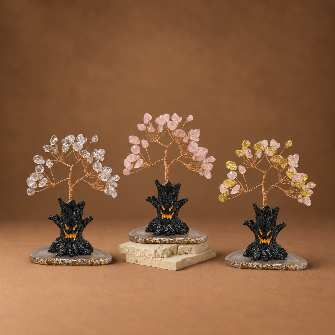 Halloween crystal tree sculpture with clear, pink, and yellow gemstone branches on black base