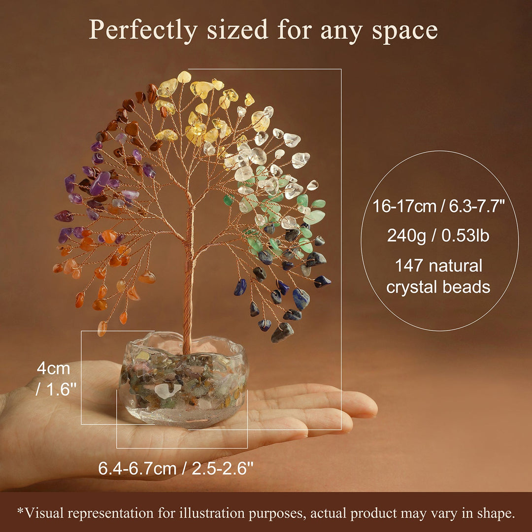 Multicolor gemstone crystal tree on stone base held in a hand