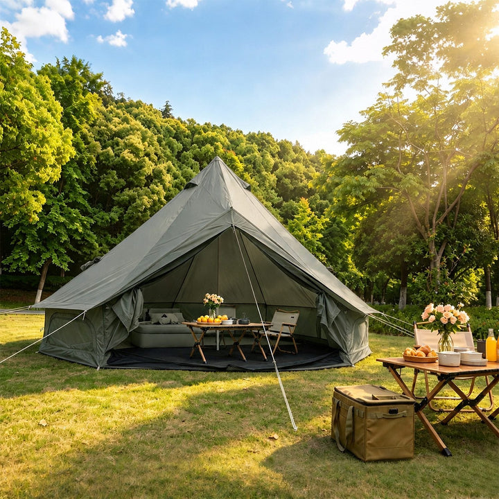 Dark green bell tent with open front and outdoor dining table near tent