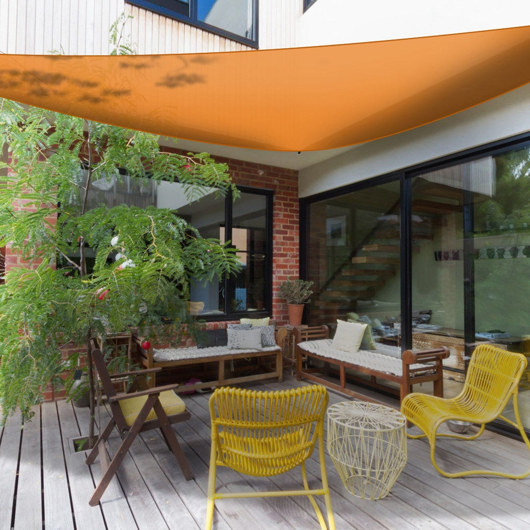Orange triangular shade sail canopy over outdoor patio seating