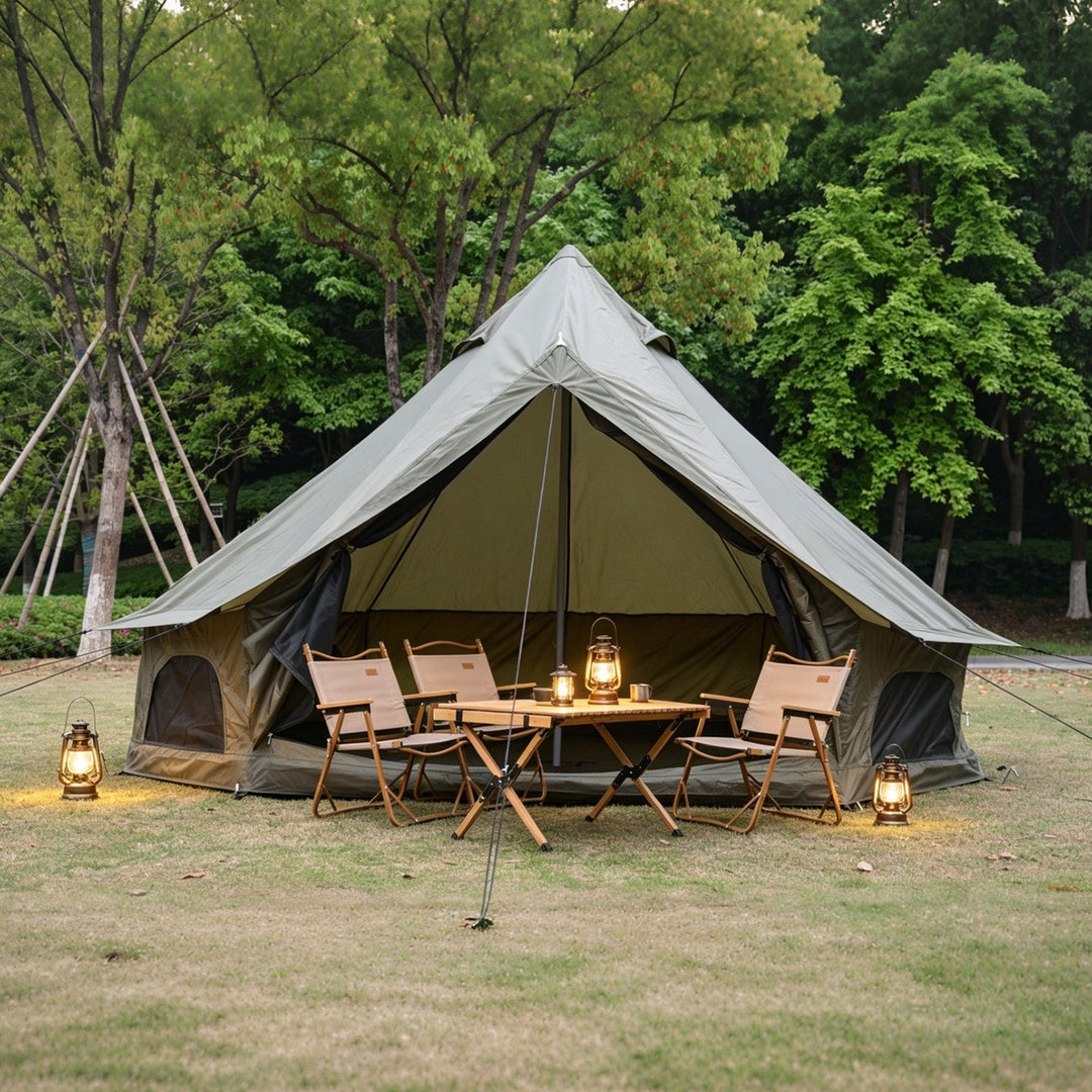 Bell tent with front dining area, glowing lanterns, open entrance and mesh windows