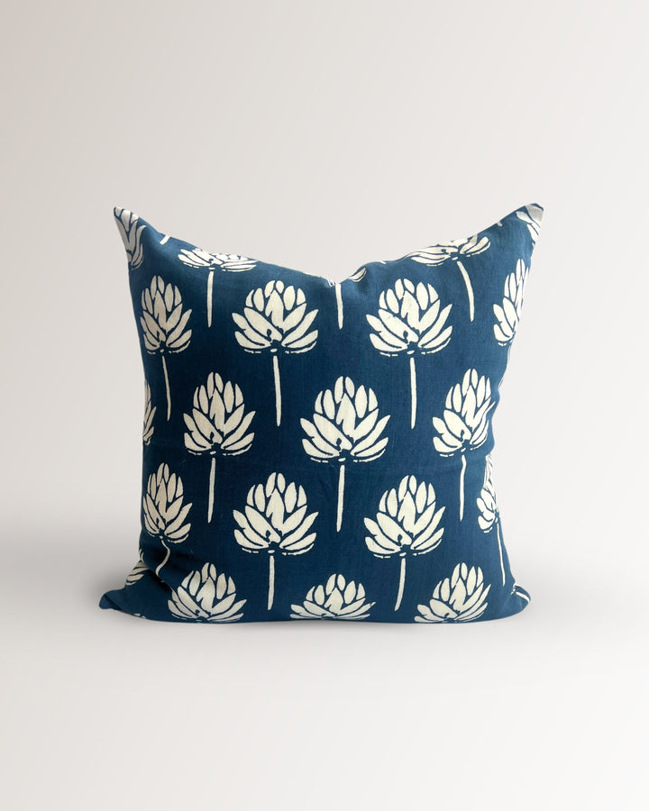 Navy blue linen pillow cover with white leaf pattern and knife-edge seams