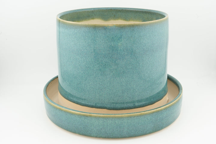 Tabletop planter set with drainage, solid teal glazed pot on teal tray with gold edge.