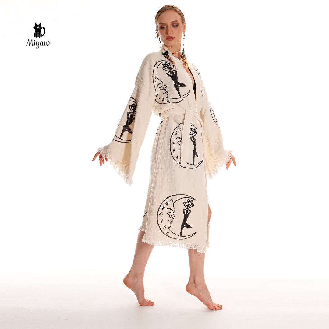 Beige cotton kimono robe front with black yoga-girl and moon prints, tassel trim