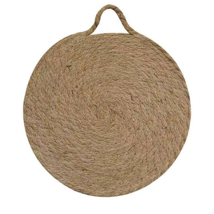 Round woven natural trivet with top handle loop, smooth woven texture visible