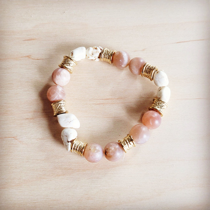 Stretch beaded bracelet with pink and white beads and gold-tone barrel spacers