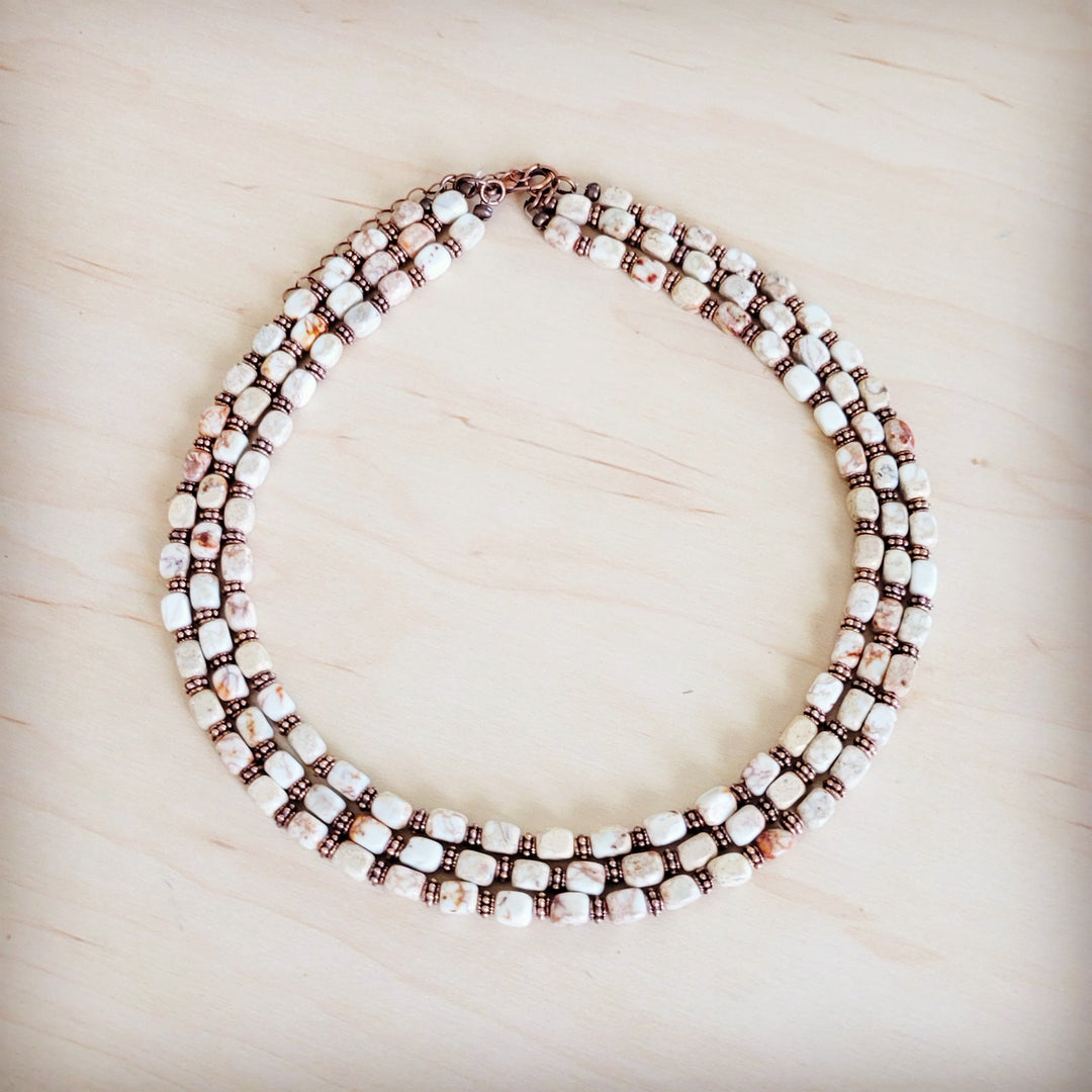 Triple-strand beaded boho necklace with white and dark bronze cube beads and copper chain