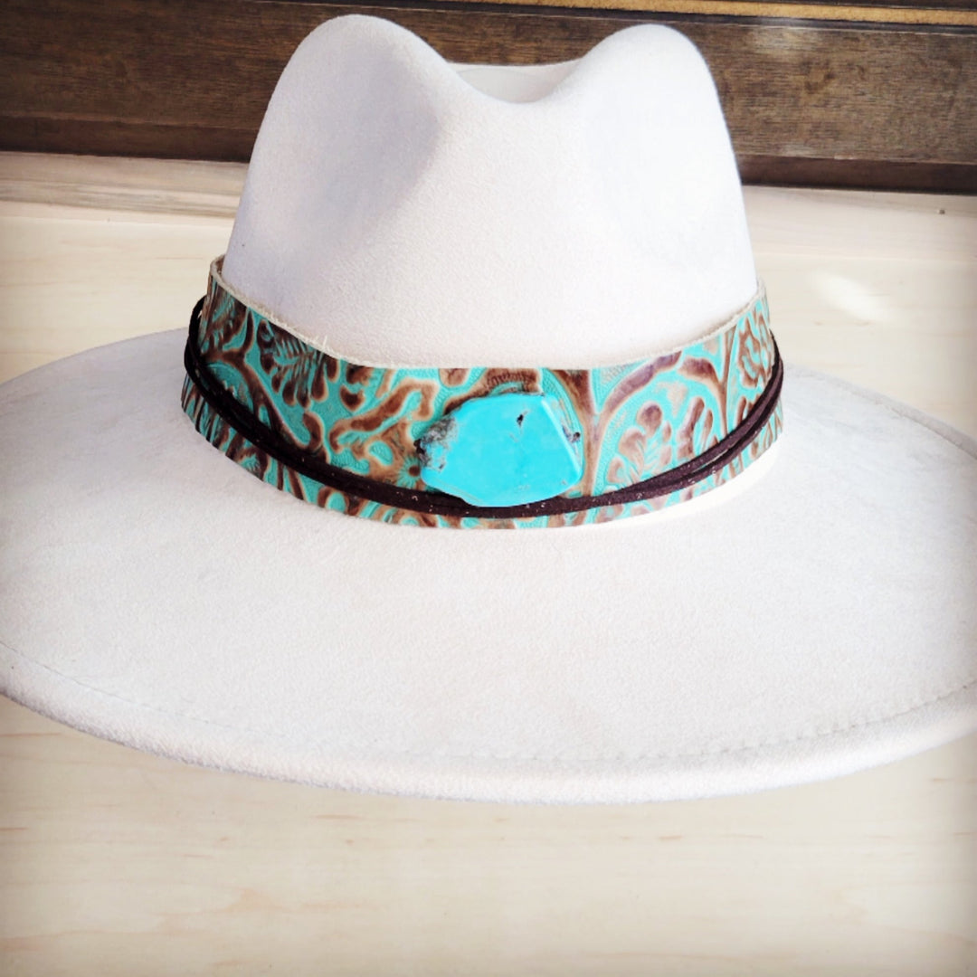 White felt cowboy hat with wide turquoise patterned leather band featuring turquoise oval center